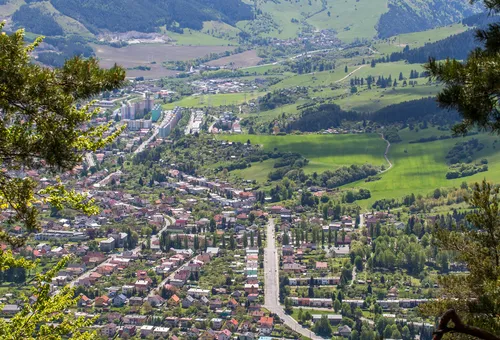 an aerial view of Ružomberok, Slovakia, surrounded by mountains