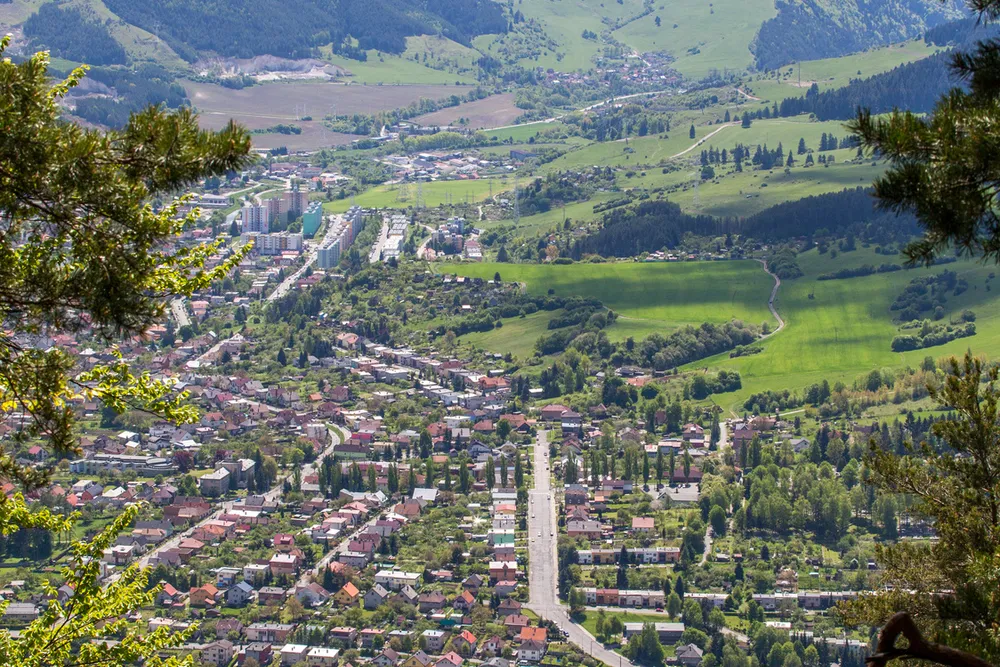 an aerial view of Ružomberok, Slovakia, surrounded by mountains