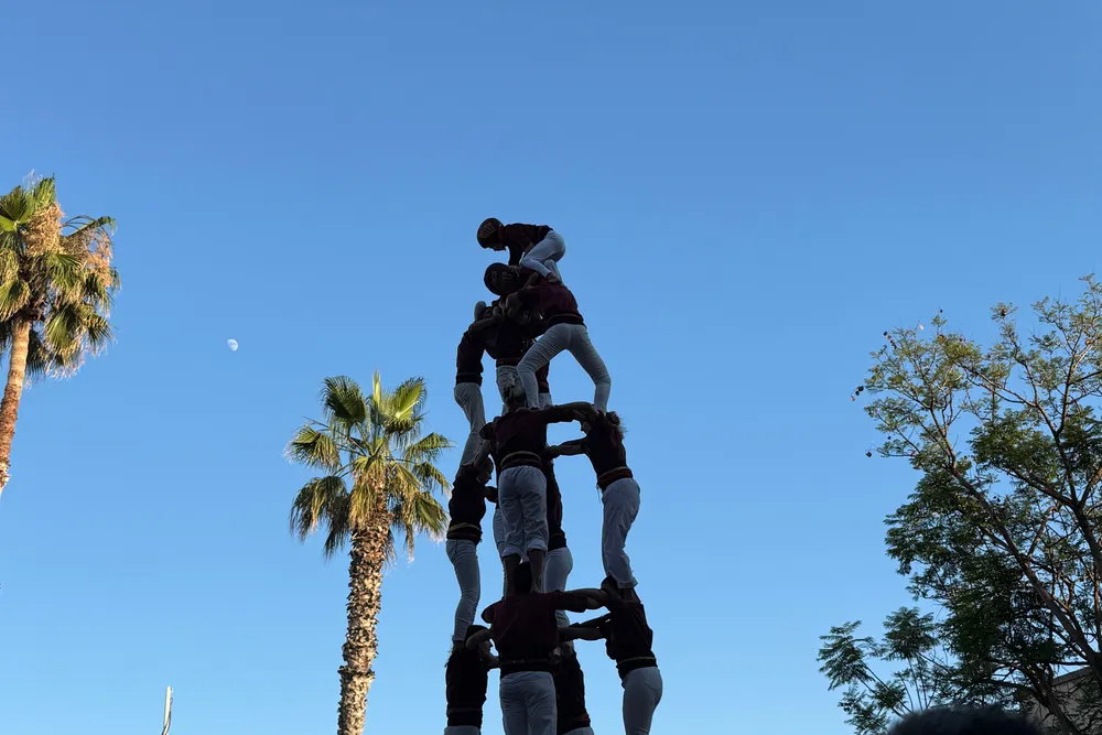 a Catalan human tower (castellers) against a blue sky