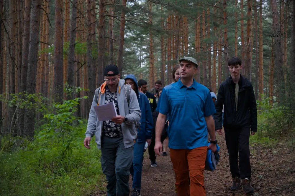 participants walking through a pine forest near Bansko during a nature-based learning session