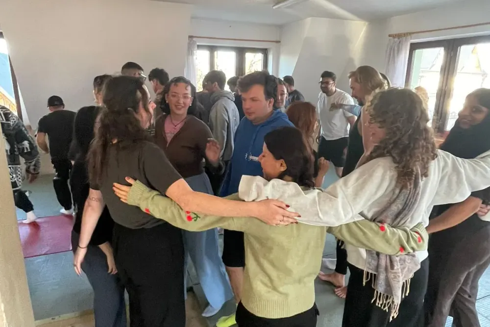 participants in a group hug during a workshop session at the Murzasichle accommodation
