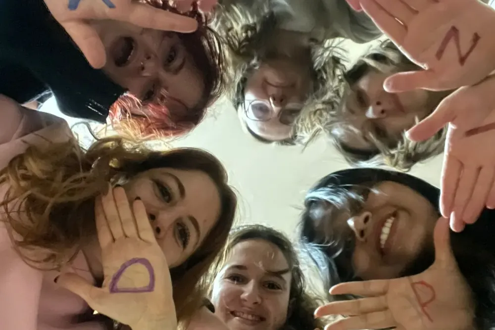 participants holding up hands marked with letters during an icebreaker activity