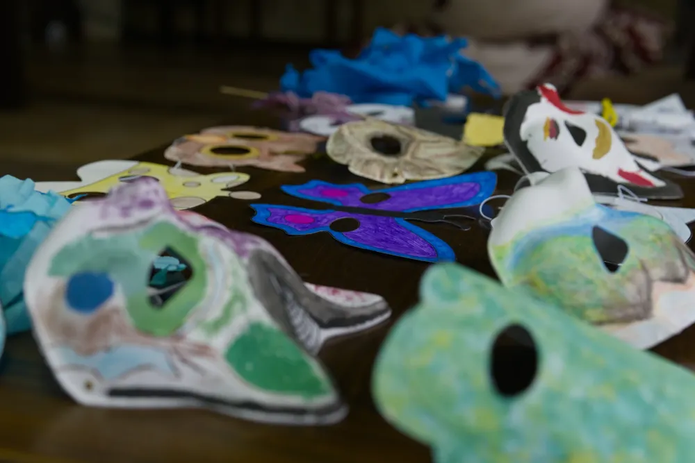 hand-painted animal masks laid out on a table, made during a Green Pathways workshop