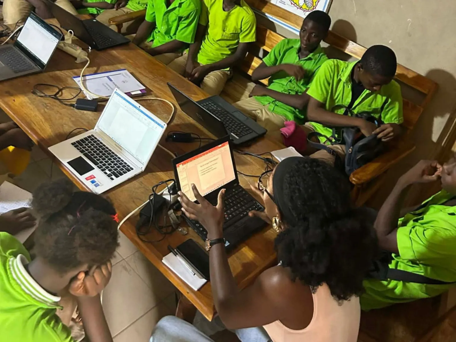 students at La Voie School sharing a handful of borrowed laptops on one table