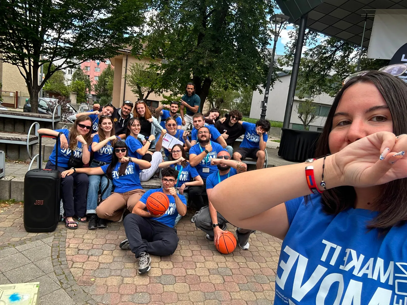 participants gathered outdoors in matching blue t-shirts during a team activity at the Think Digital exchange